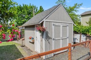 small tan garden shed in a yard